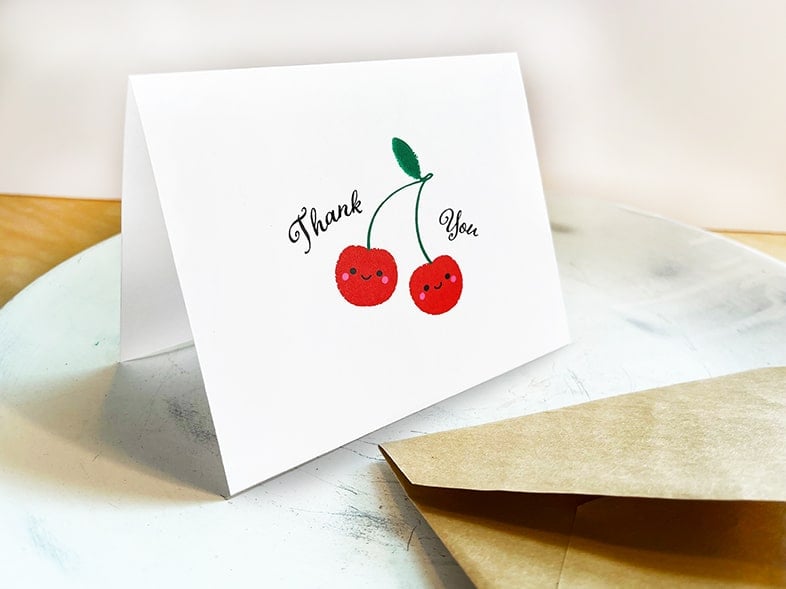 Feature image of Cherries Thank You Card at an angle with envelope in front.