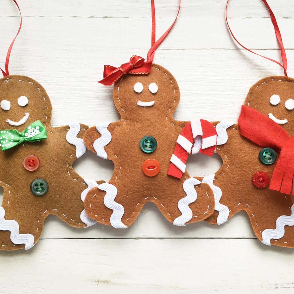 Square feature photo of three finished handmade felt gingerbread man ornaments.
