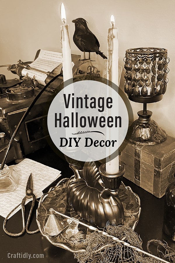 Vertical photo of a vintage Halloween vignette with a crow on a vintage typewriter and candleabra in the foreground on a black desk. The tone is spooky and eerie and the photo is sepia. Please pin this image to your Pinterest craft boards to come back the this Vintage Halloween DIY Decor ideas using thrift store finds!