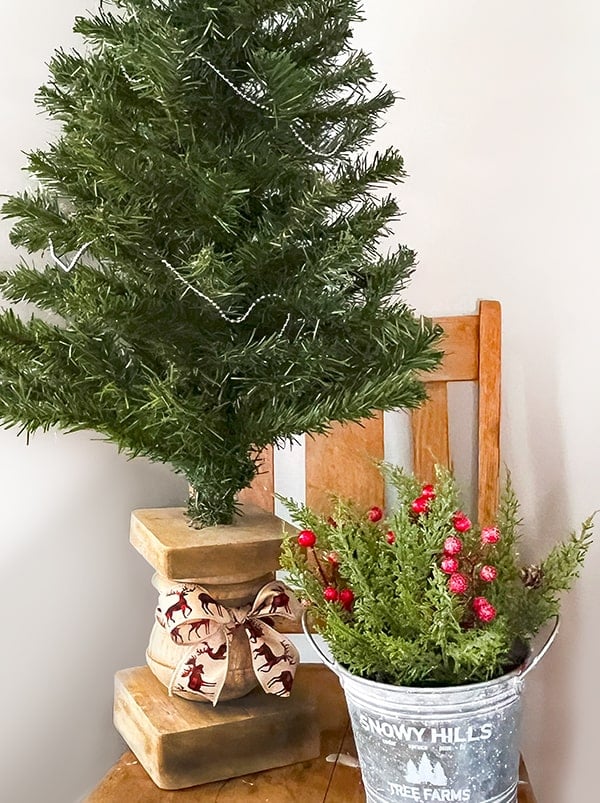 Shown is a chunky wood baluster that has been drilled to hold a 4 foot tall Christmas Tree. This is a wood salvage piece found at a yard sale and upcycled.