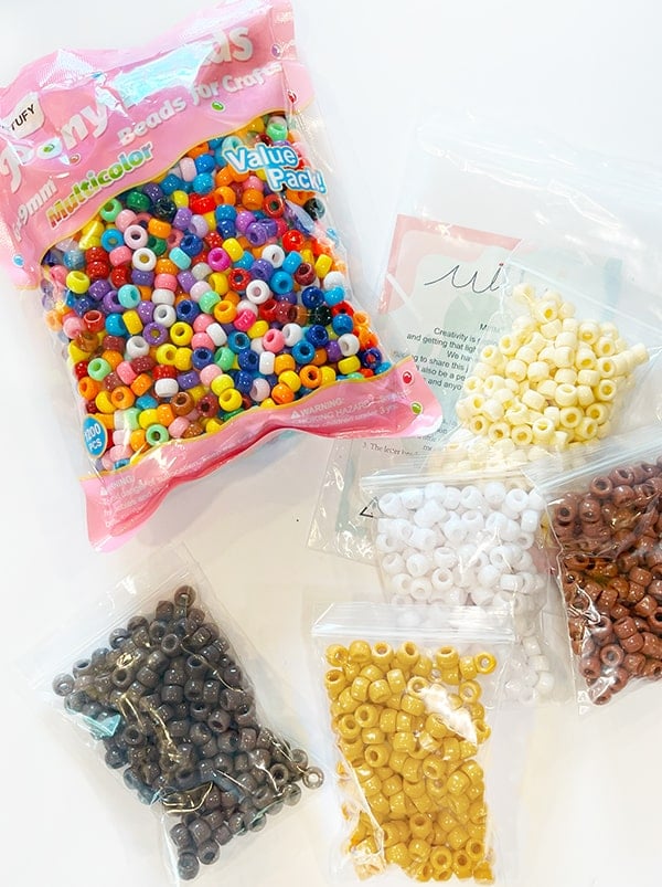 Photo of bags of pony beads in multi-color and browns that were used in this graduated pony bead bracelet.
