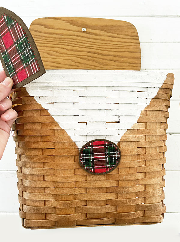 Assembling the reindeer basket by painting a white v-shape for the face before gluing the nose on.