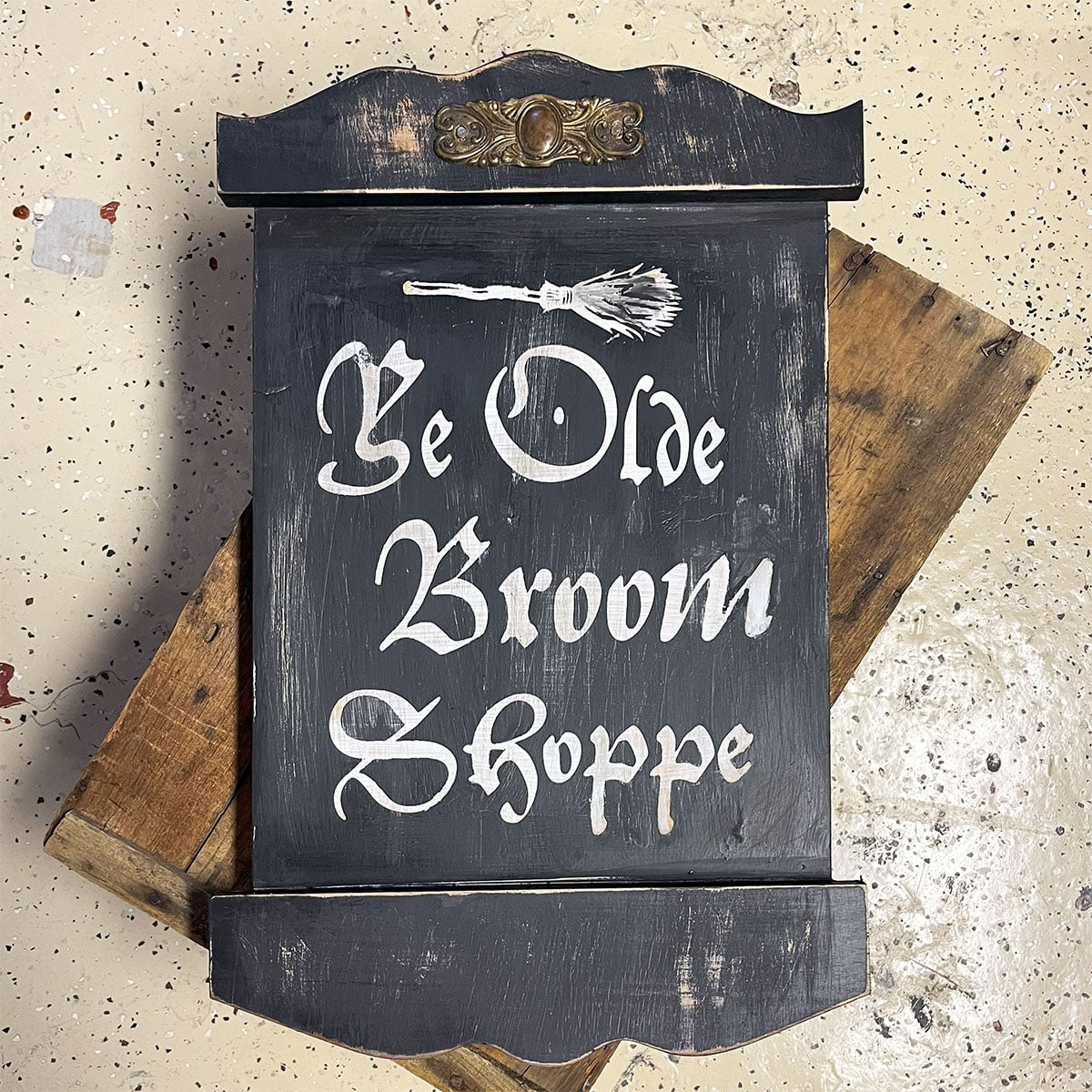 Ye Olde Broom Shoppe - this is a closeup of a handmade wooden sign for Halloween. The type is old English style with curved wood top and bottom pieces to add to the look!