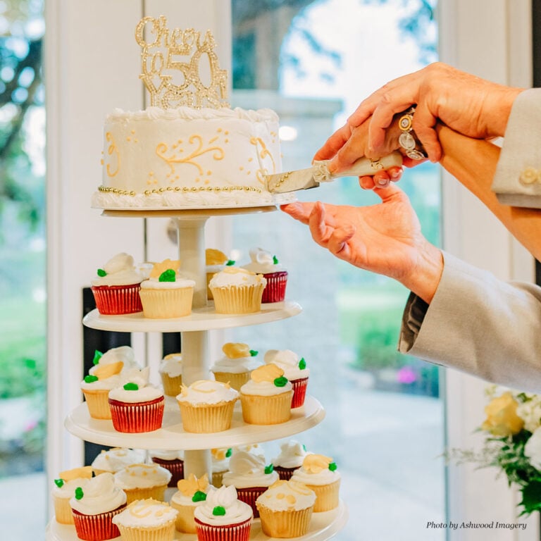 50th Anniversary- Close up photo of cutting the cake. Photo by Ashwood Imagery.