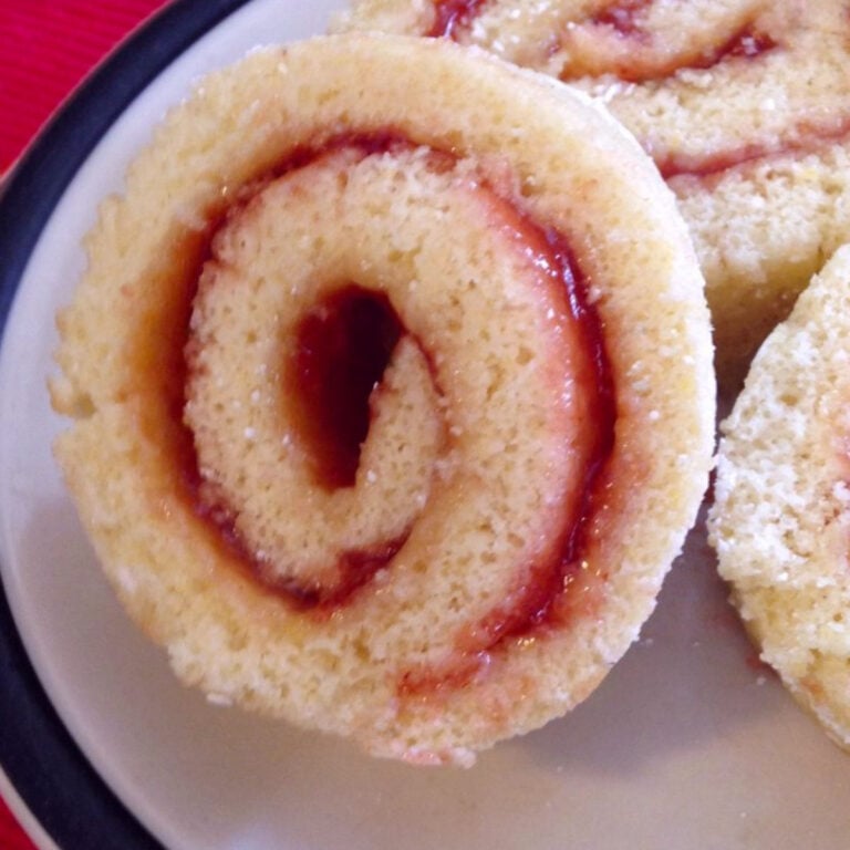 Closeup of a jelly roll cake plated old fashioned jelly roll on a stoneware plate.