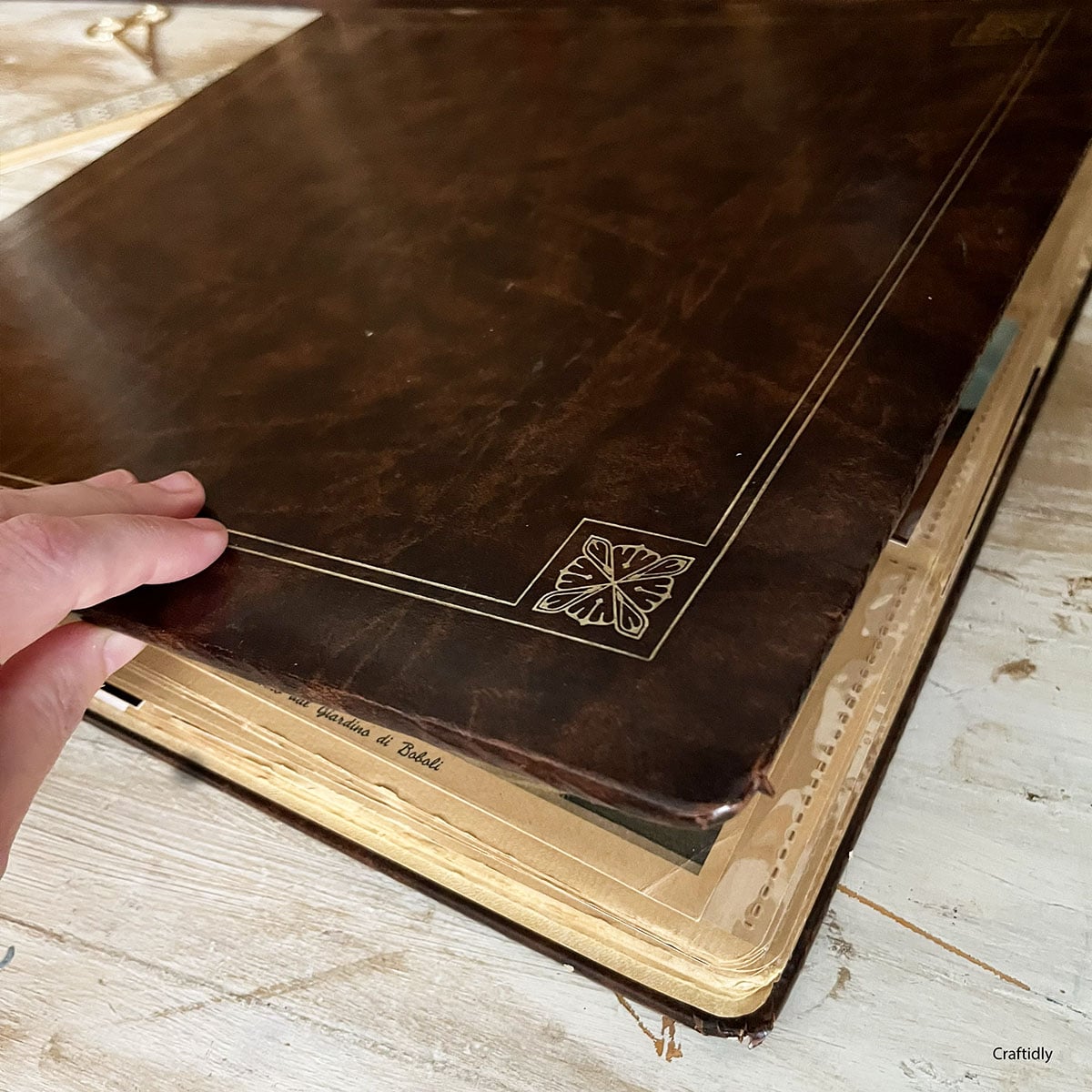 Closing an old album found at an antique store in Pennsylvania USA. It contains travel photos and postcards collected abroad. The cover is brown and it holds six postcards/photos per inside plastic sleeve pages.