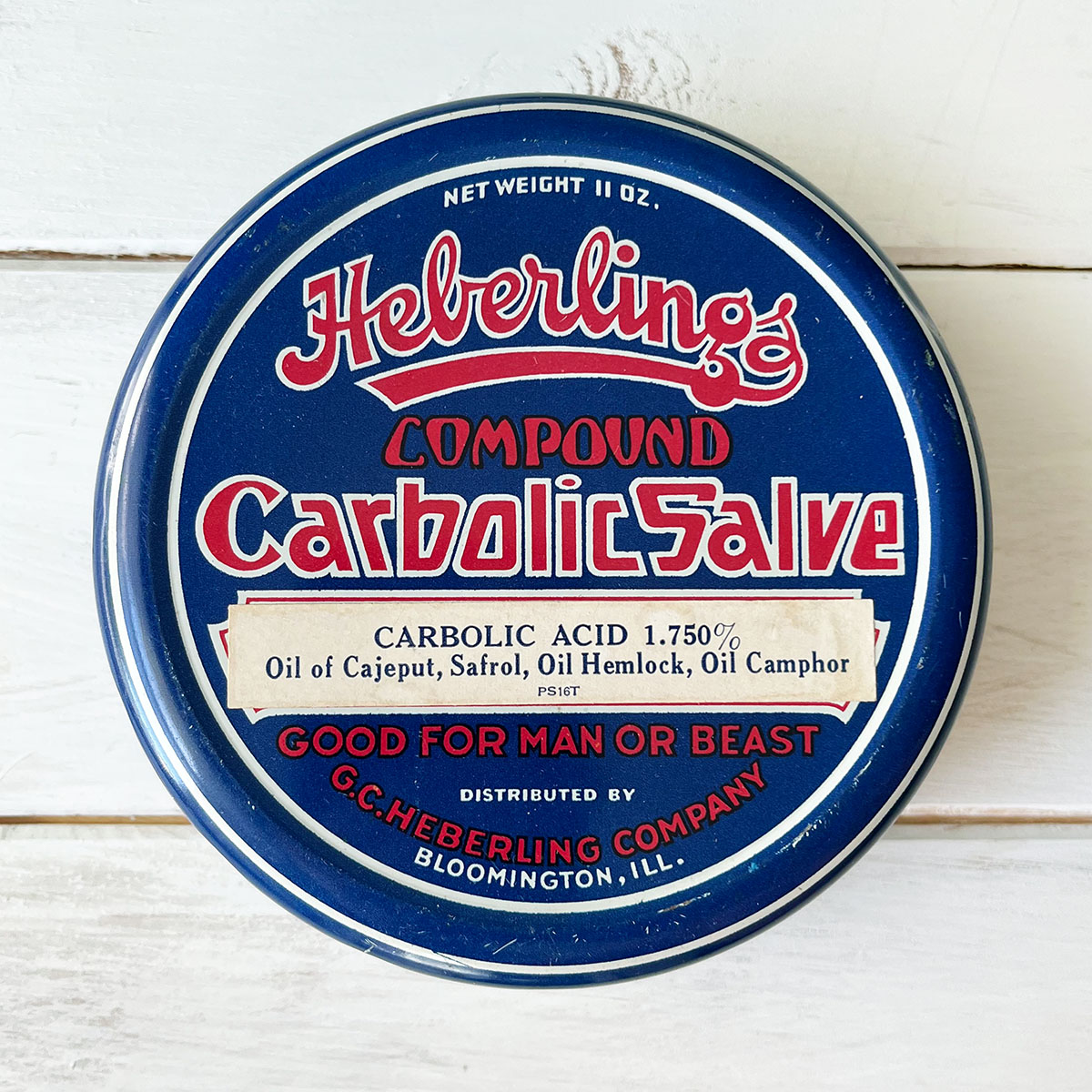 Vintage tin in patriotic blue with red type and white accents. Heberlings Combound Carbolic Salve.