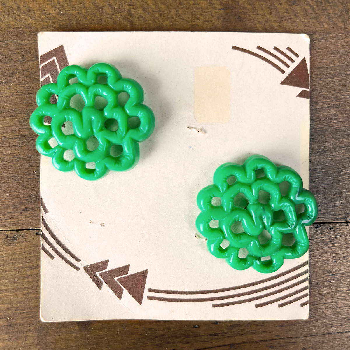 Large green floral buttons on the original cards. The card is ivory with brown swooping arrow details.
