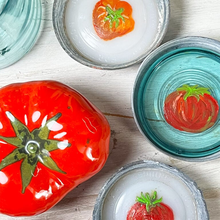 Hand-painted tomato designs displayed inside vintage canning lids with milkglass and aqua glass inserts on a weathered white wood background.