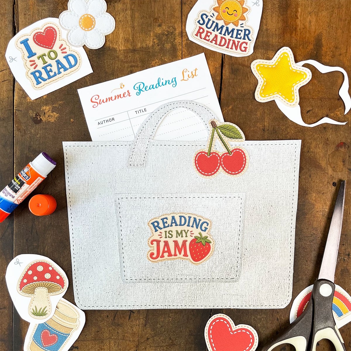 Paper Snail Club summer reading tote printable with a reading list, colorful patch decorations, scissors, and cutout paper pieces ready to assemble.