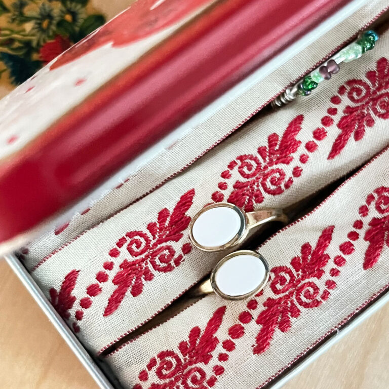 Square feature image - Open Altoids tin transformed into a DIY travel ring holder with fabric-covered ring rolls and two rings inside.