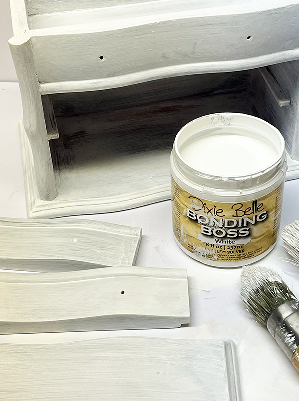 Applying Dixie Belle Bonding Boss primer to a thrift store jewelry box before painting.