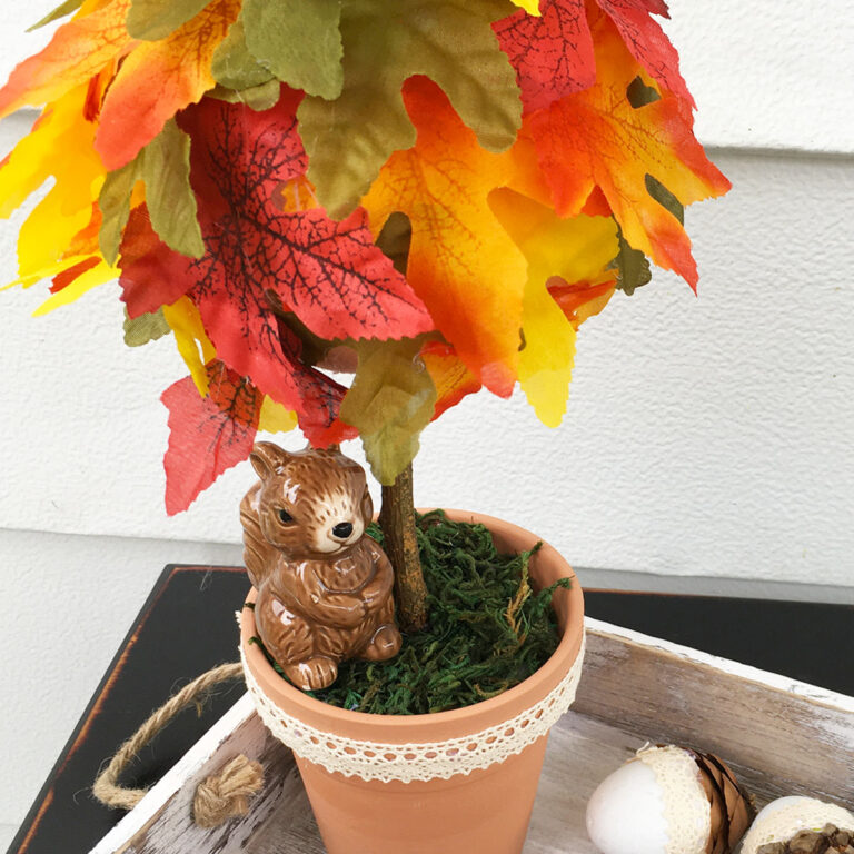 Finished 12-inch tall topiary made using a small terracotta pot as the base, a branch and a foam ball with fall silk leaves glued to the top.