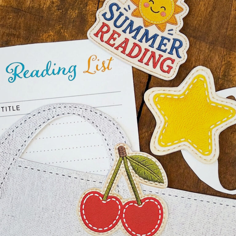 Thumbnail closeupf photo for The Paper Snail - Summer 2026, featuring summer reading paper crafts. Shown is a closeup of a cherry paper patch on a paper reading tote, a sunny summer reading patch and a Summer Reading List sticking out of the bag.