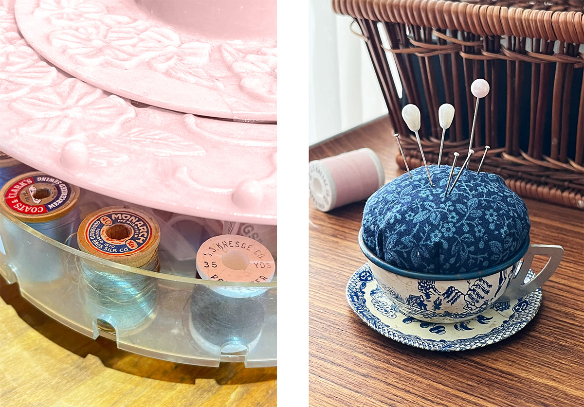 Left image: Close-up of vintage wooden thread spools with colorful paper labels tucked inside the translucent compartment of a pink sewing notion holder. Right image: Blue-and-white vintage child’s teacup and saucer repurposed as a pincushion with dark blue floral fabric and assorted pearl-topped pins.